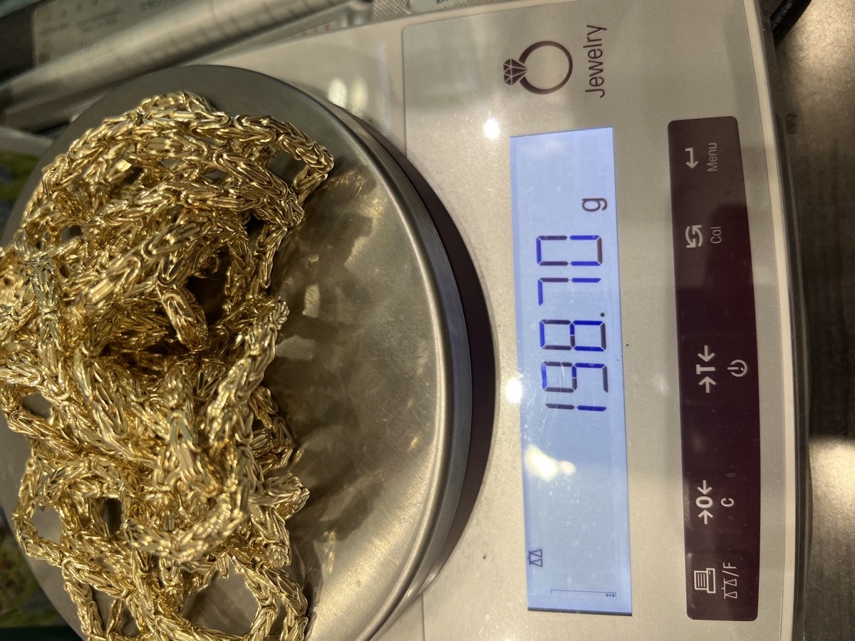 Gold chain weighed on a digital scale, 198.70 grams